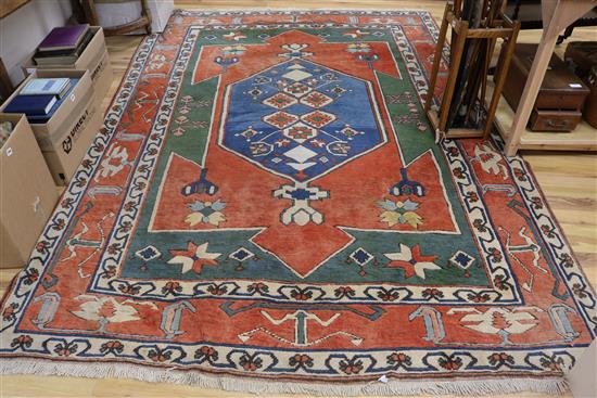 A Heriz red-ground carpet 300 x 215cm